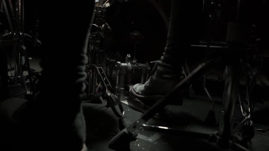 Drummer plays on his drum pedals