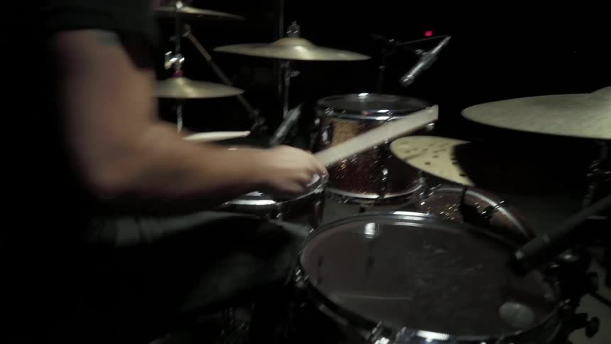 Man plays drums energetically