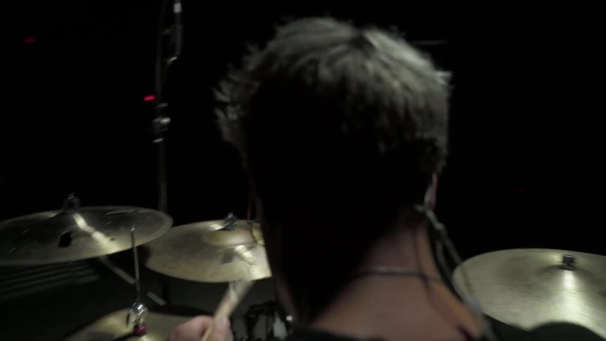 Drummer plays on his drum kit