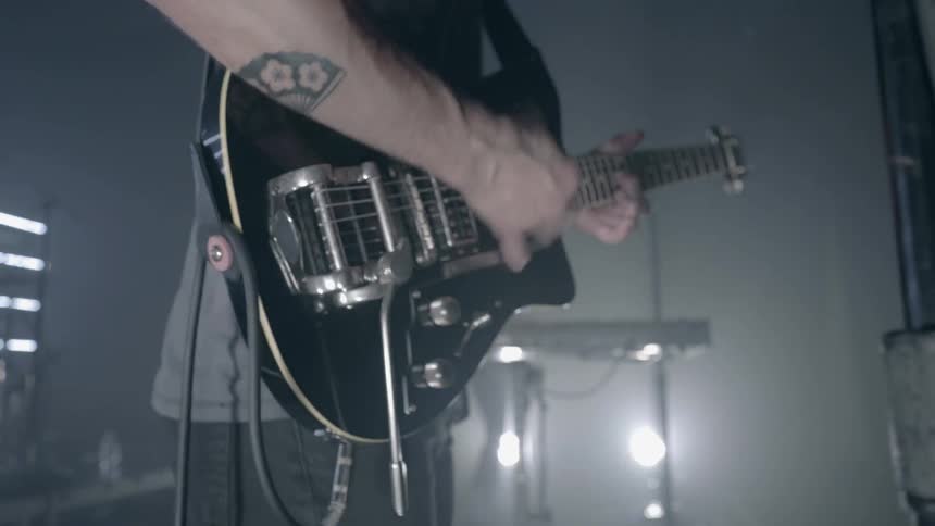 A man is playing guitar on stage