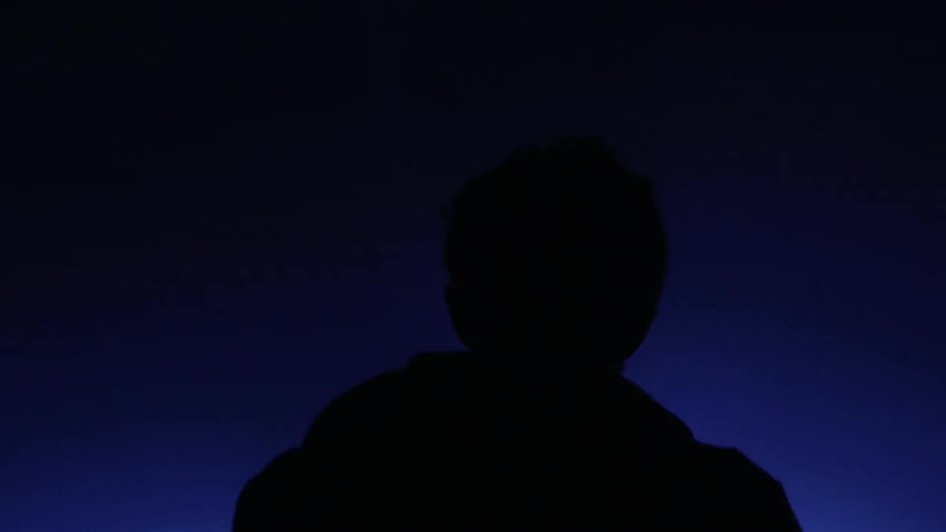 A silhouette of a man on stage