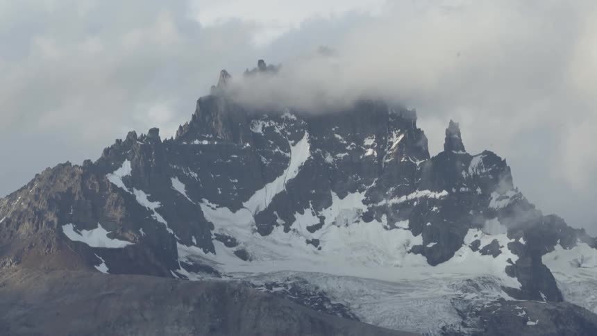 The clouds cover the mountaintop