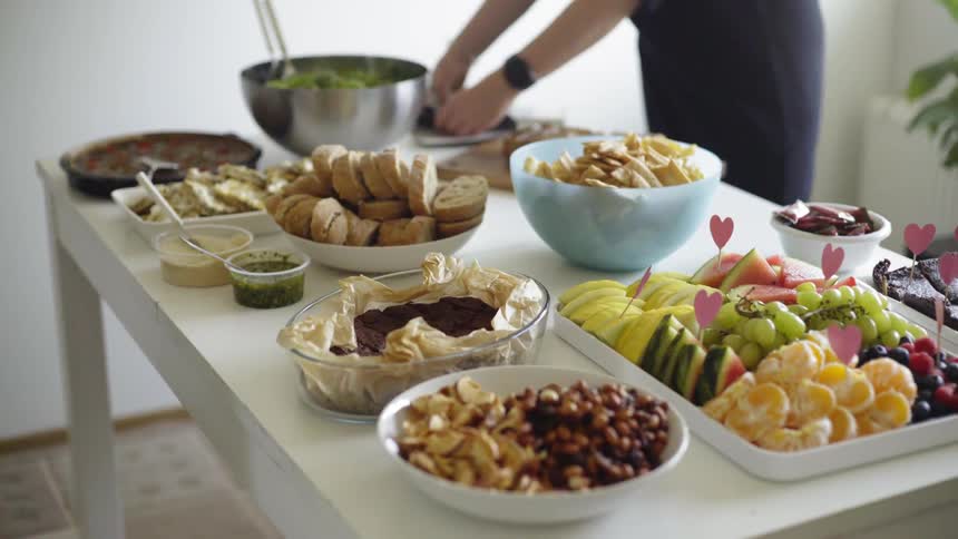 A woman is putting food on the table