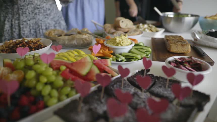 Several women help themselves to a spread of food