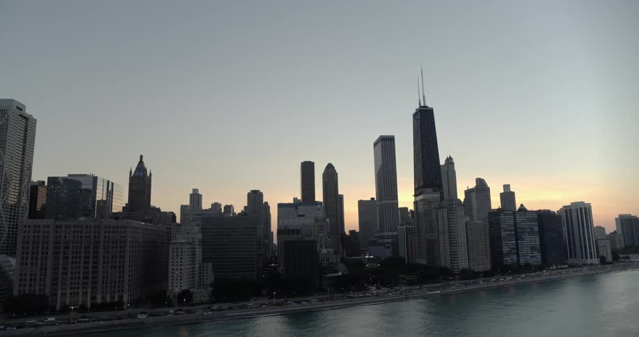 Cars drive along the lakefront in front of downtown chicago