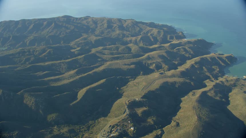 Hills and valleys meet an ocean