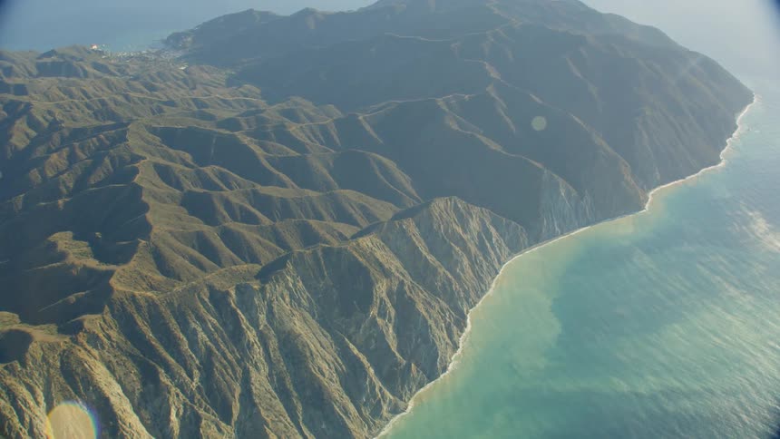 A mountain range forms a peninsula that juts out into the ocean