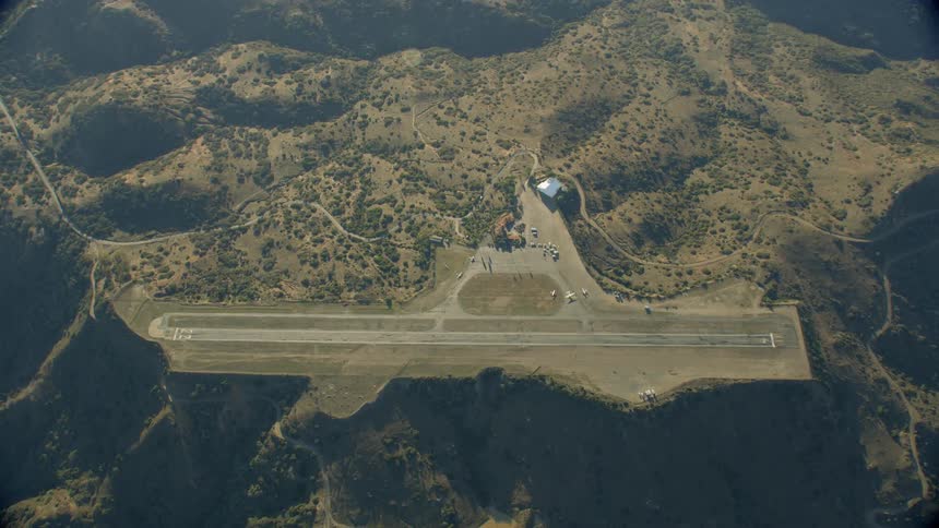 Aerial view of a landing strip on an edge of a cliff
