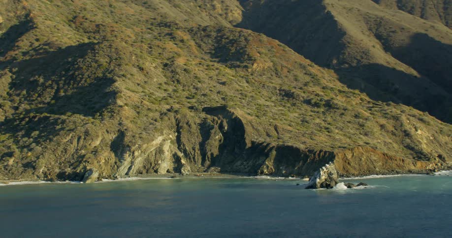 Waves crash along Catalina's rocky mountain coastline