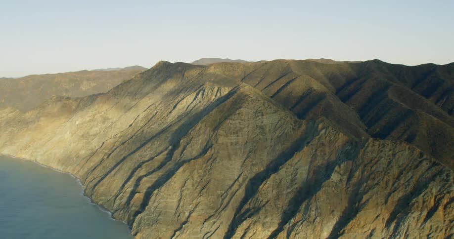 Range of mountains seaside in the daytime