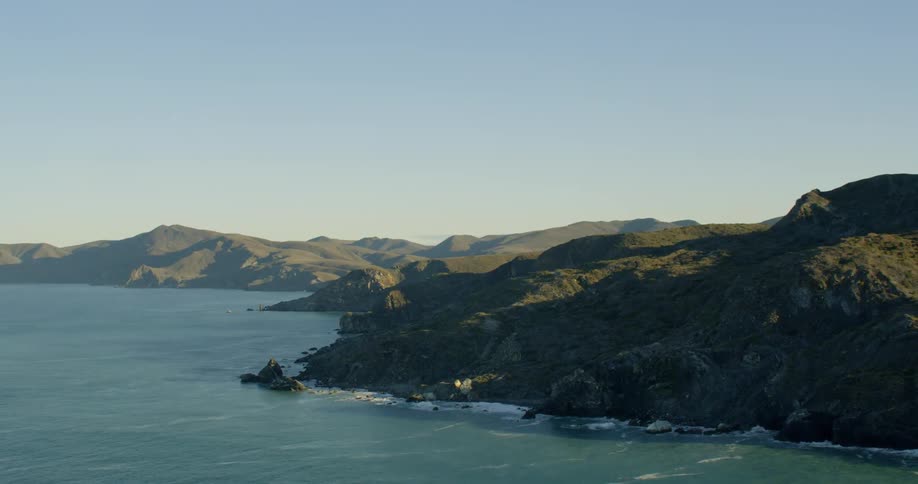 A mountainous coastline during the day