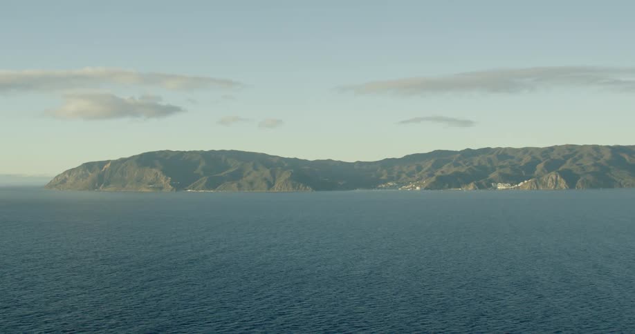 A landmass in the ocean during the day