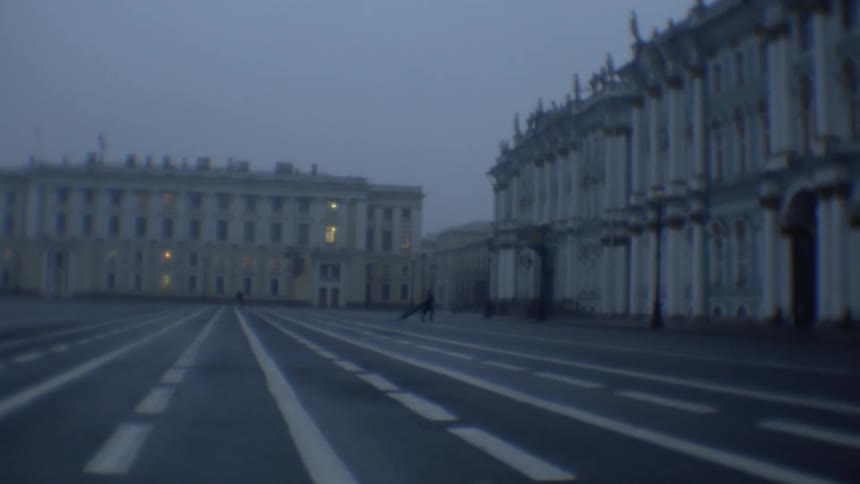 A person runs across a foggy courtyard