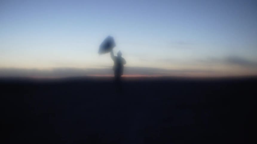 The silhouette a person with an umbrella