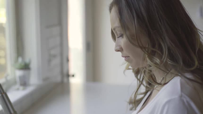 Woman looks up in the kitchen in the daytime