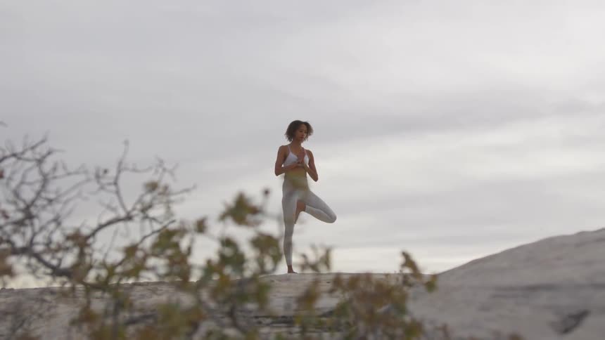 Woman does yoga outdoors