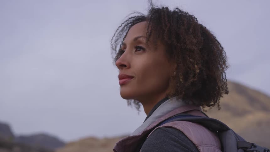 A woman gazes out into nature