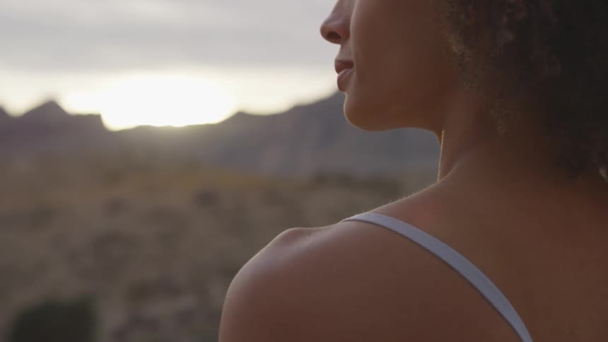 A young woman looks across the horizon