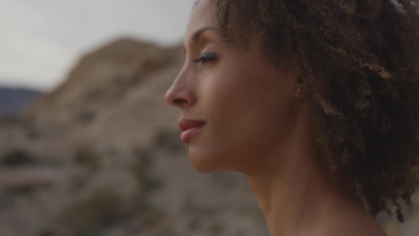 Woman looking at the horizon on a desert