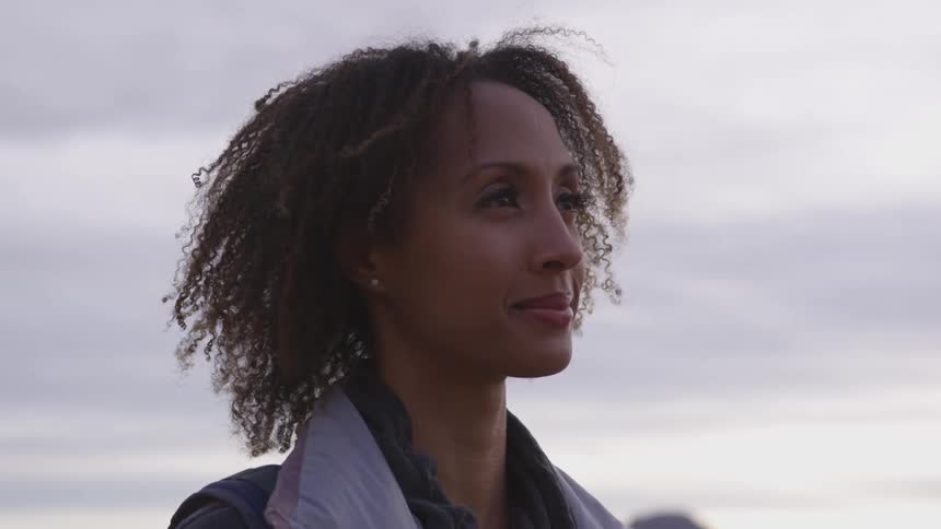 A woman is standing outside looking up
