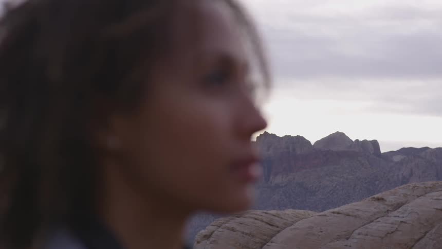 Woman contemplating the horizon on a desert
