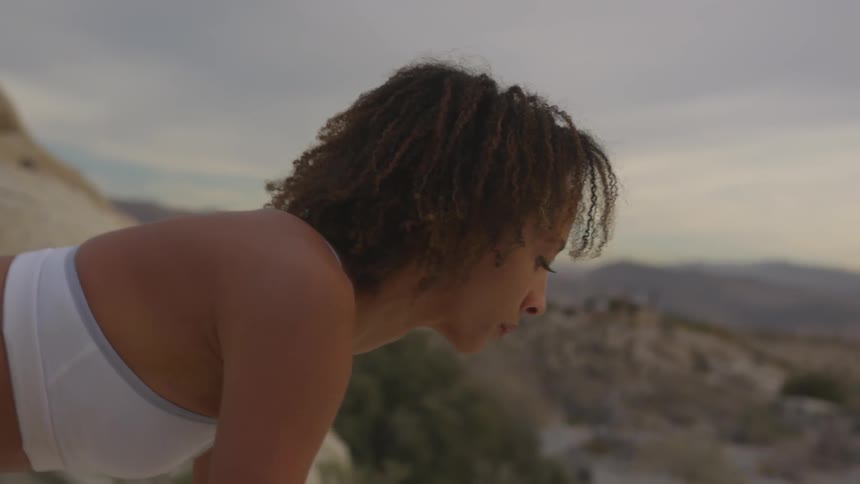 A woman is stretching outdoors