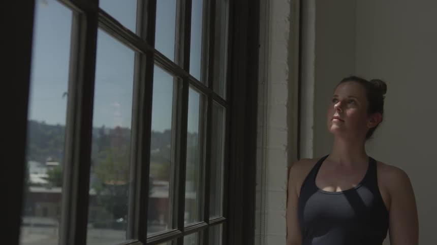 A woman looks out of a window