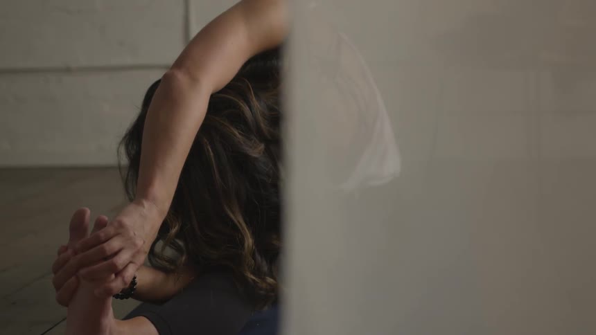 A woman leaning over to her left side stretching out her body
