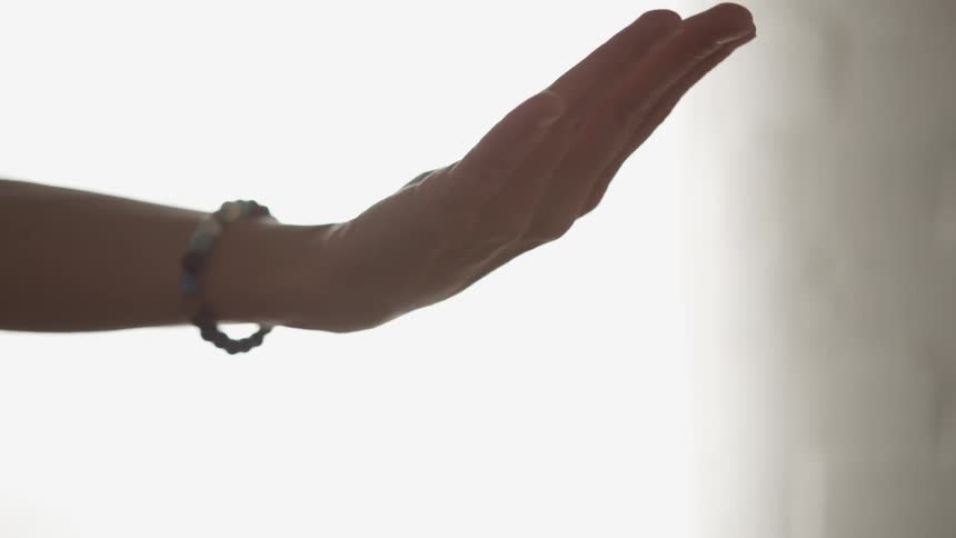 A woman's hand rotates and then she opens her palm