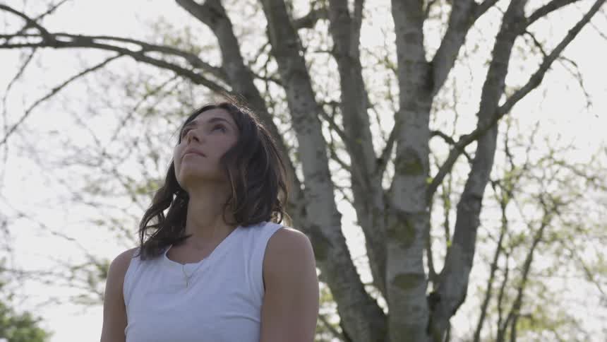 A white woman does yoga outdoors
