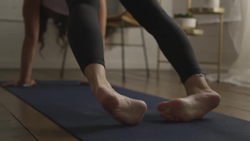 A young woman performing yoga on a mat