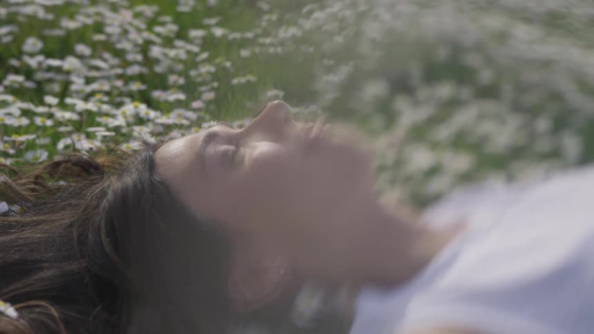 Woman laying down on flowers
