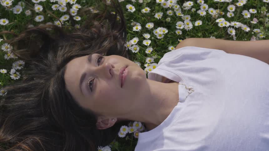 Woman laying down on flowers