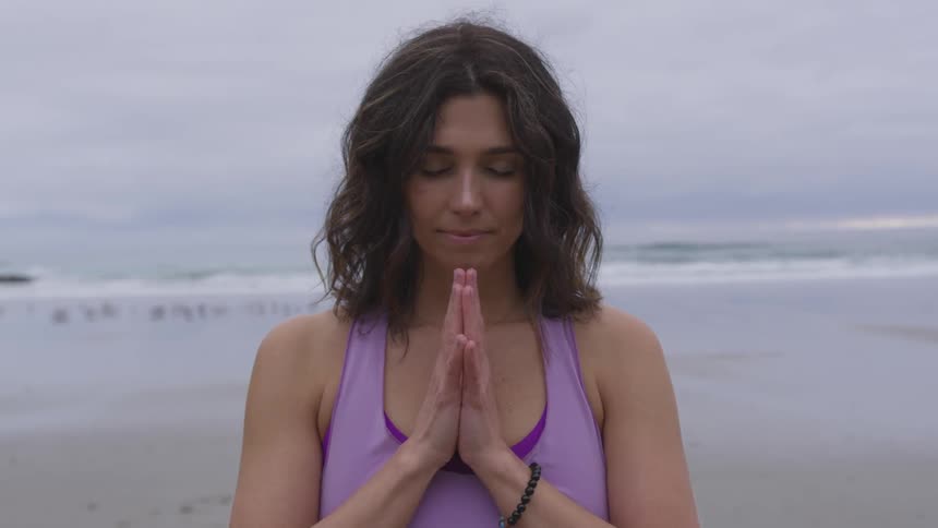 A woman is doing yoga outdoors