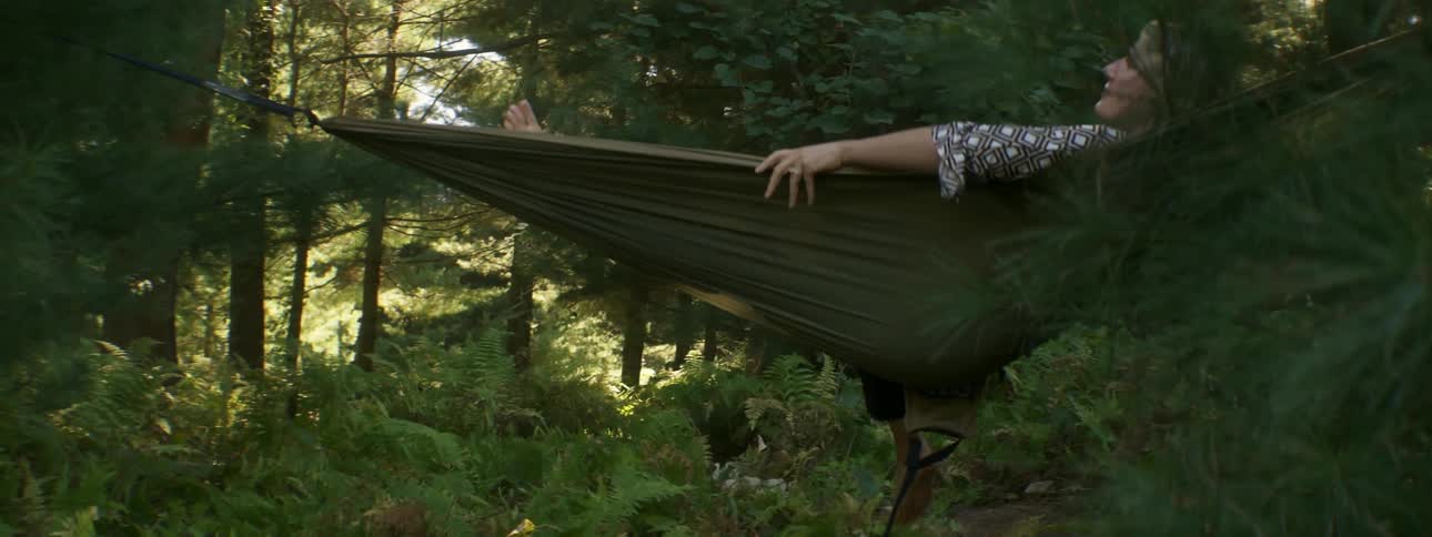 Woman lays down in a hammock