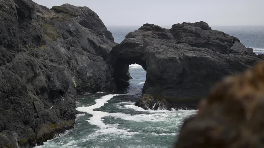 Water rushing through an opening in a cliff