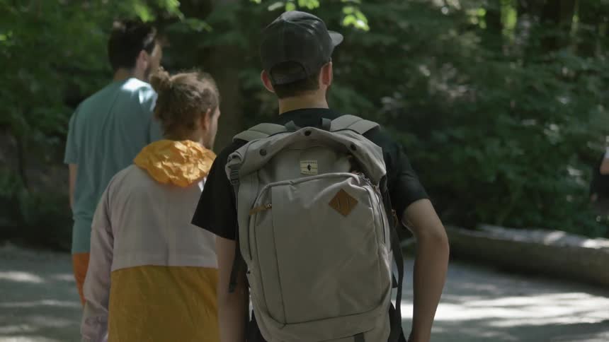 Man and kids walk through the woods