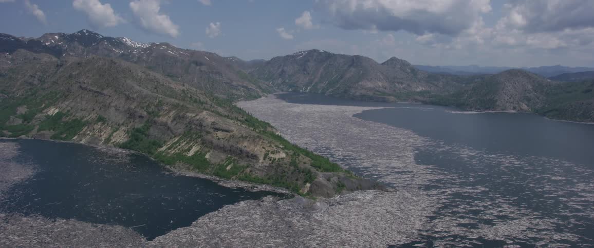 An aerial shot of a coastal area with mountains