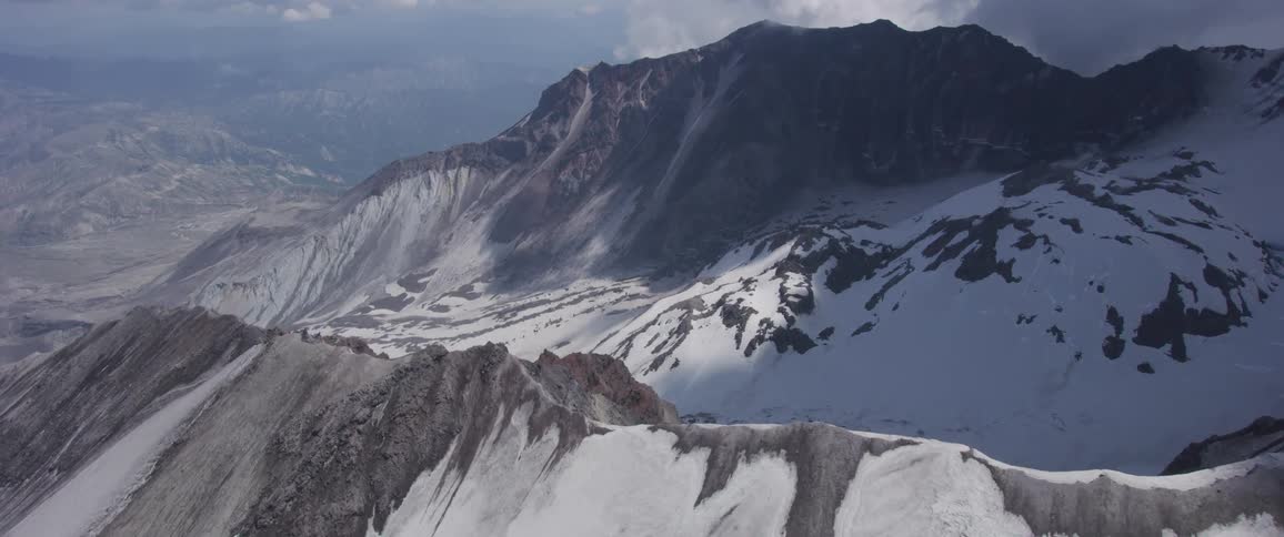 A stony mountain ridge covered in snow