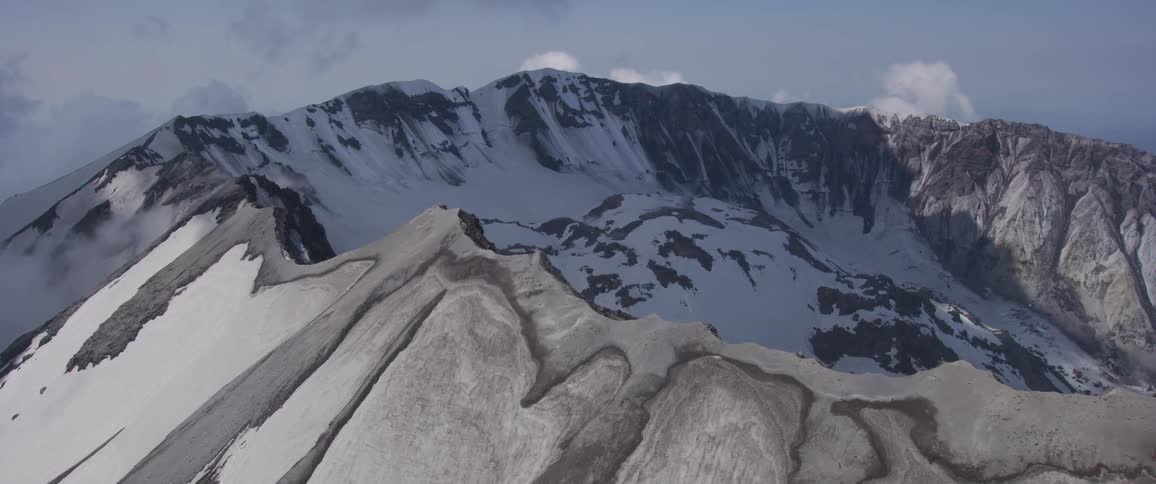 A stone mountain ridge covered in snow