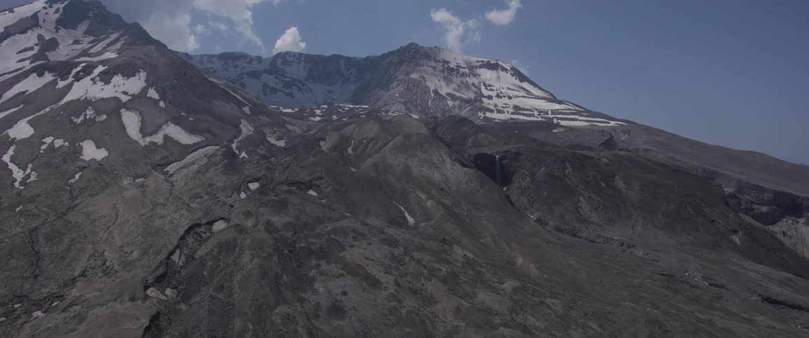 An aerial view going up the side of a mountain