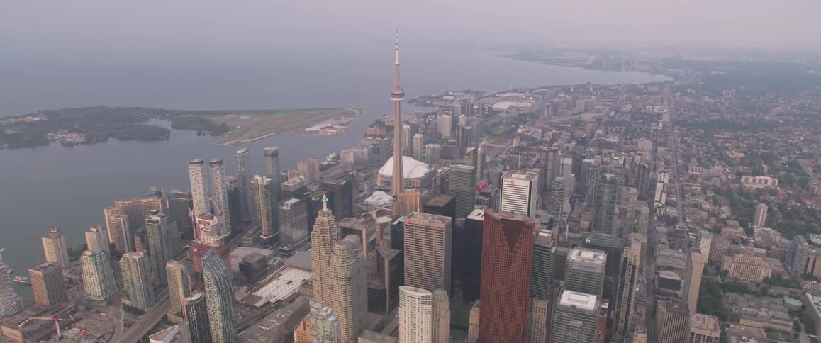 Skyline of the city with tall skyscrapers next to the sea by day