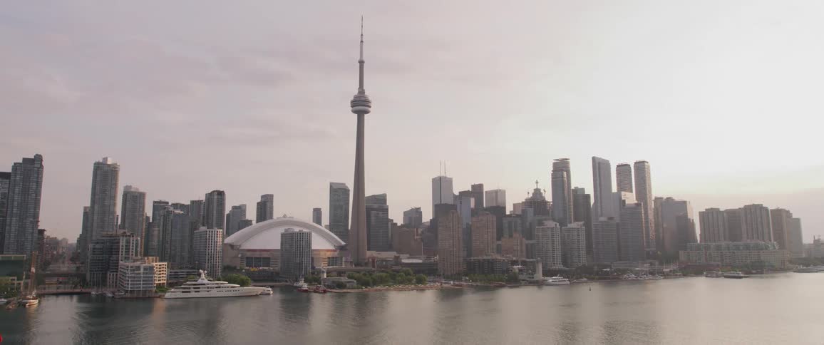 The camera flies next to a city on a river
