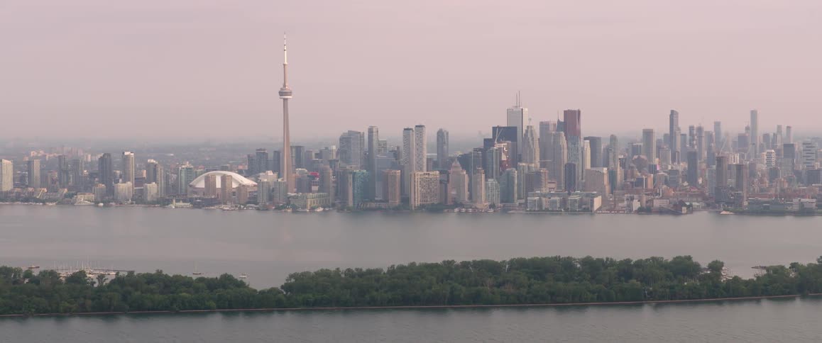 Skyline of the city with tall skyscrapers next to the sea in the daytime