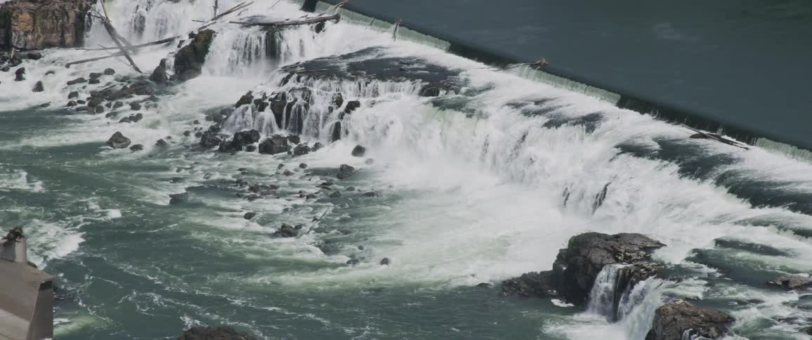 Water rushes over a dam