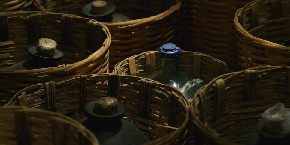 A static shot of a bottle in a basket