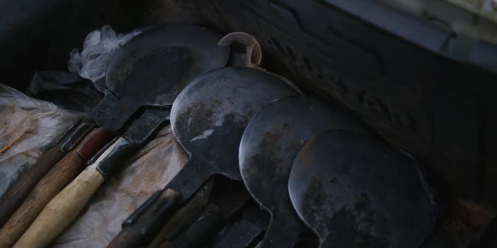 Rounded metal headed tools in a box