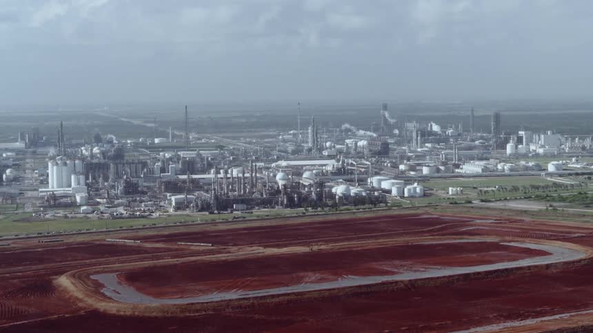 Aerial view of a chemical refinery and a massive chemical pool