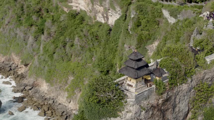 An aerial view of a building perched on a coastal cliff