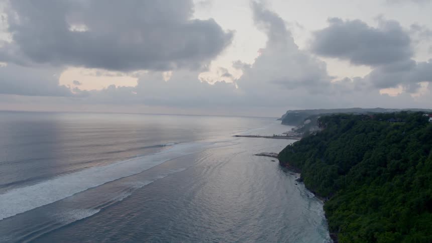 Ocean waves roll to a rocky coast